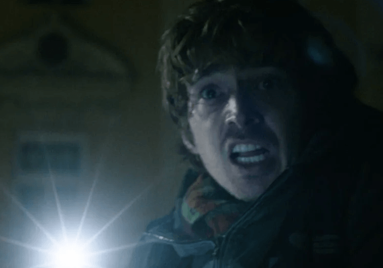 A man shining torchlight in Resident Evil