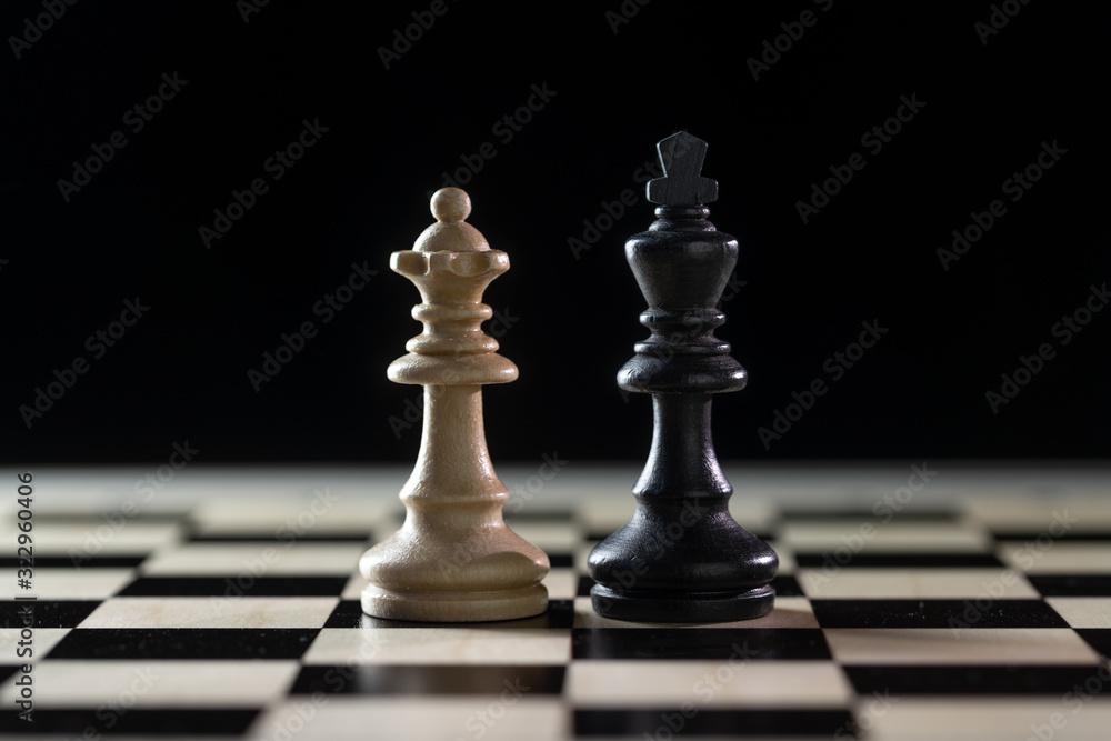 Two chess pieces, white queen and black king side by side on a chessboard  against a dark background, concept for diversity, gender equality and  cooperation, copy space Stock Photo | Adobe Stock