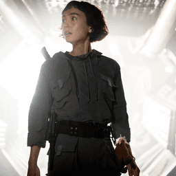 A character looking to her right while light emanates from behind her in Alien: Earth