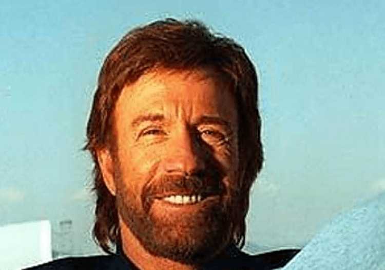 Chuck Norris sitting and smiling
