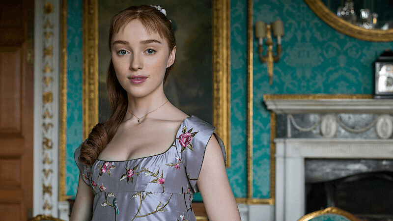 Daphne Bridgerton standing and smiling slightly