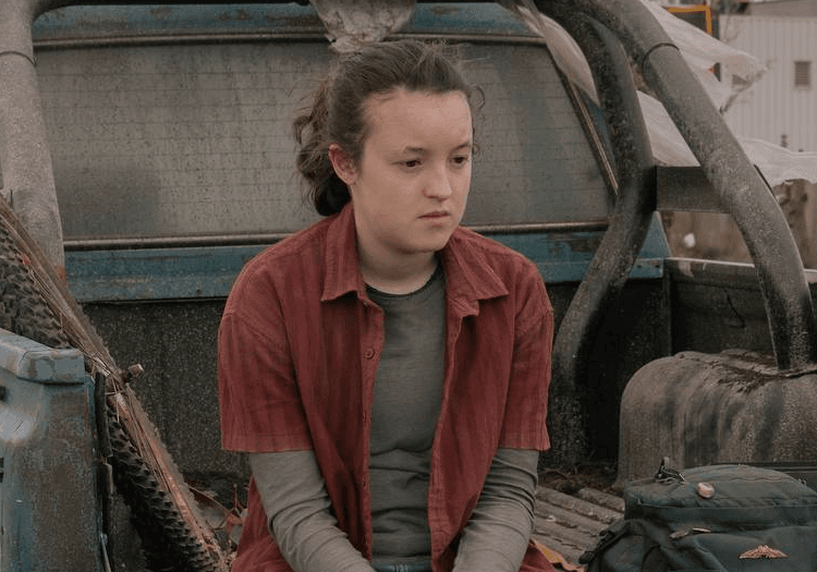 ellie sitting devastated or sad