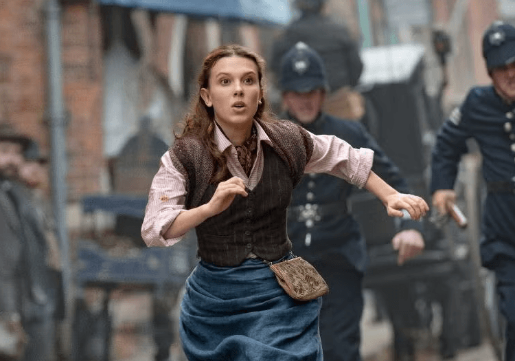 Enola Holmes running on the street shocked