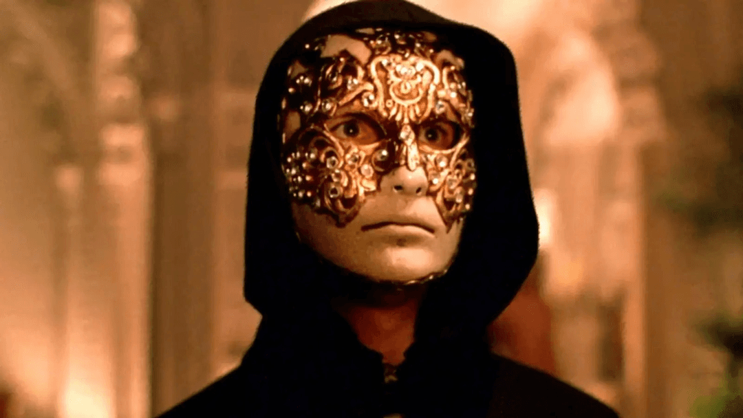 A man wearing a mask and looking straight