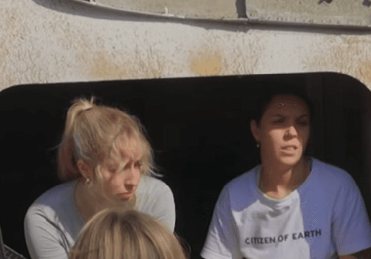 Two contestants arguing intensely over food rations at camp