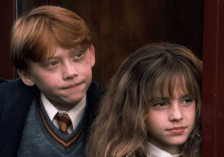 Ron and Hermione standing and looking aloof