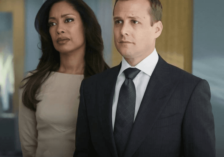Harvey and Jessica Pearson standing and looking ahead