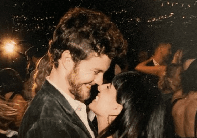 Jack Quaid smiling at Claudia Doumit