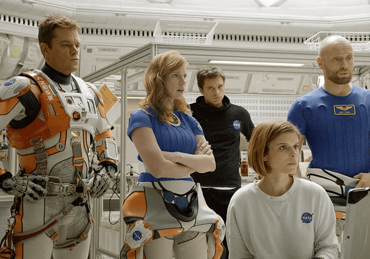 Matt Damon and other actors standing in The Martian