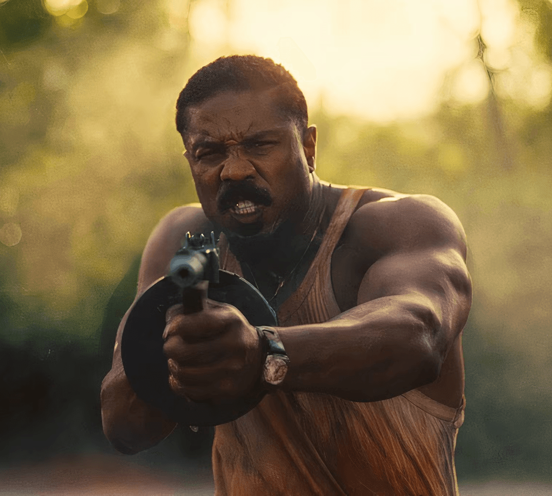 Michael B. Jordan holding a tommy gun in Sinners