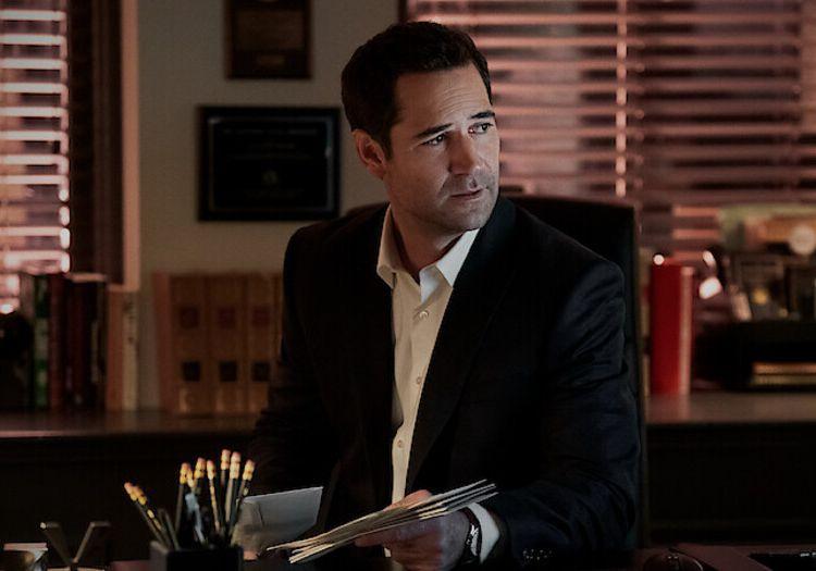 Mickey Haller reviewing files at his office desk at night