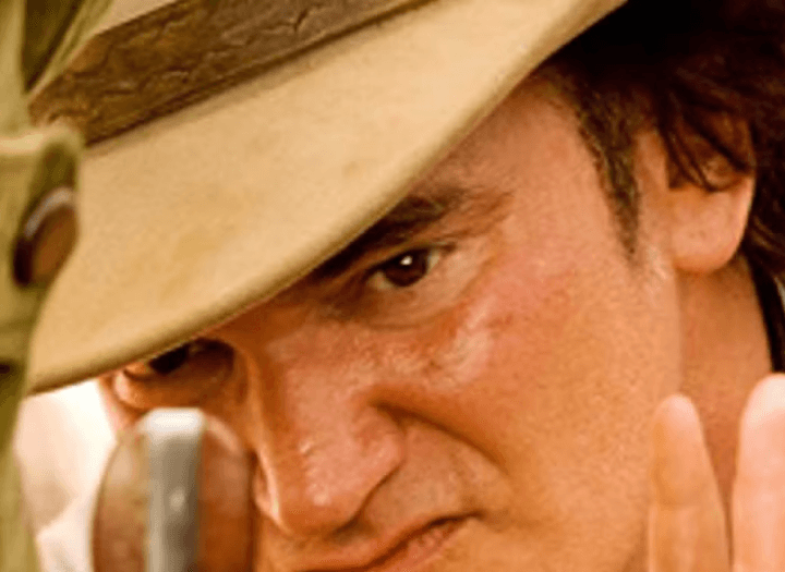 Quentin Tarantino looking at a pistol in Django Unchained