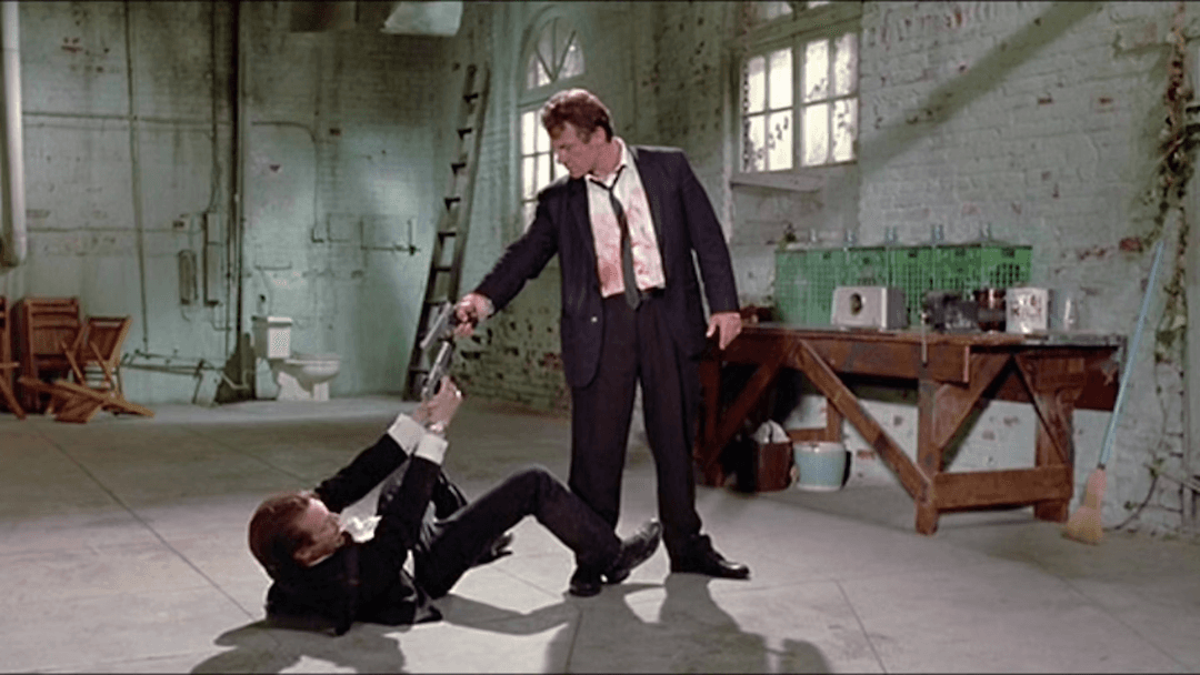 Two characters pulling a gun on each other in Reservoir Dogs