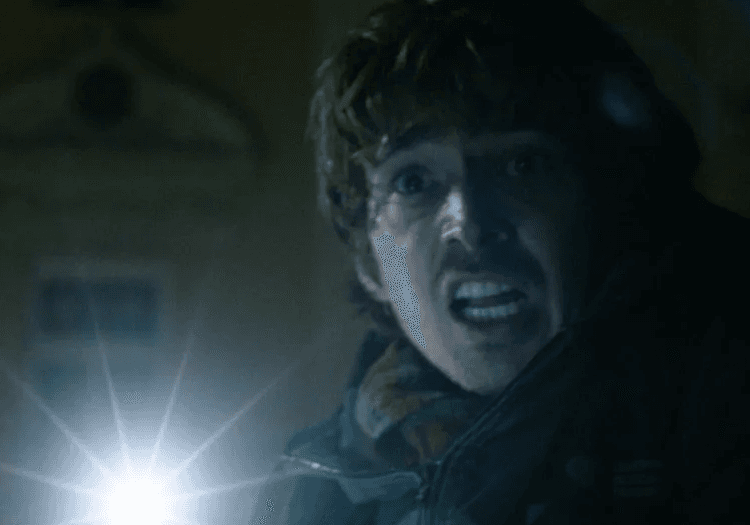 A man shining torchlight in Resident Evil
