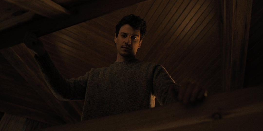 a man opening a casket or an entrance to the room