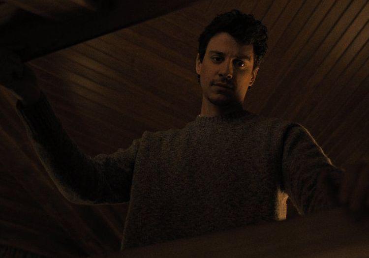 a man opening a casket or an entrance to the room