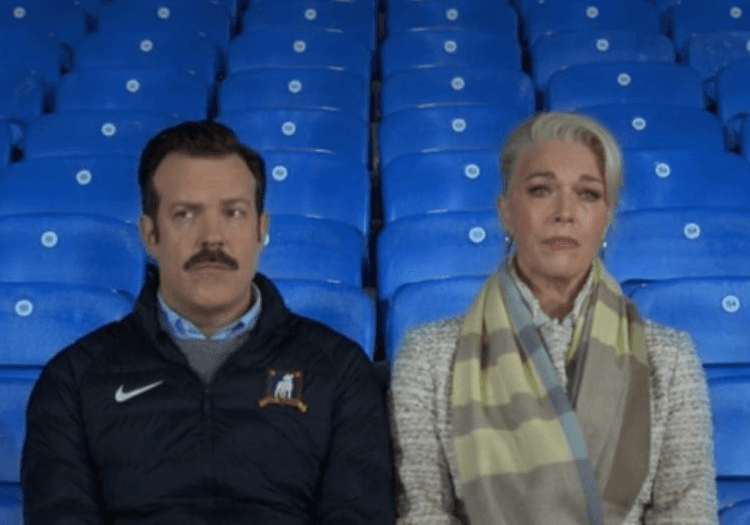Ted Lasso and a woman sitting