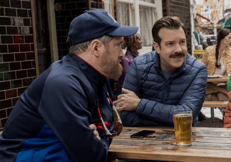 Ted Lasso and a man sitting