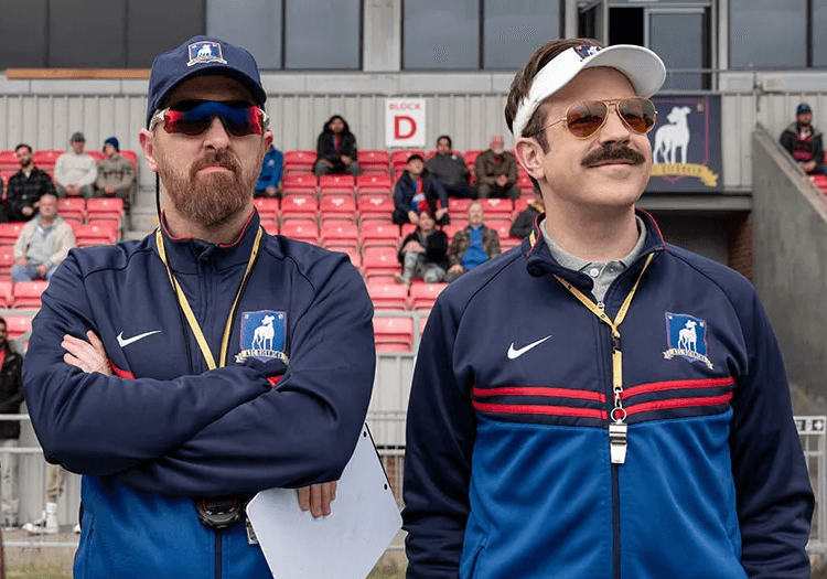 Ted Lasso standing with a man