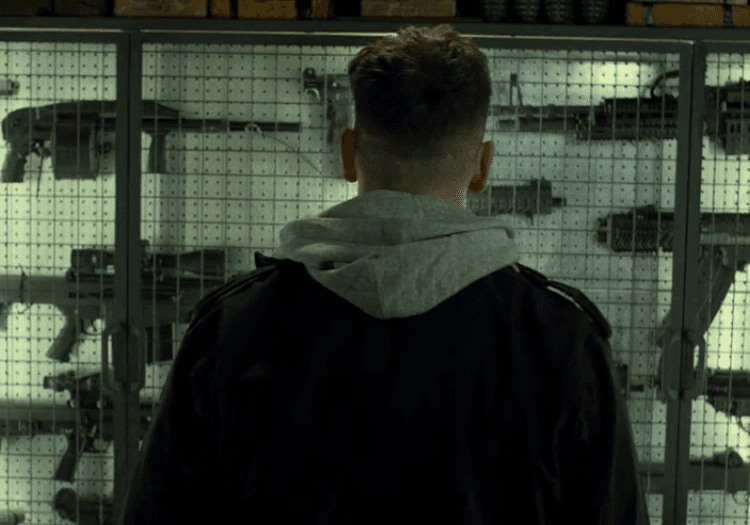 Frank Castle looking at guns in The Punisher
