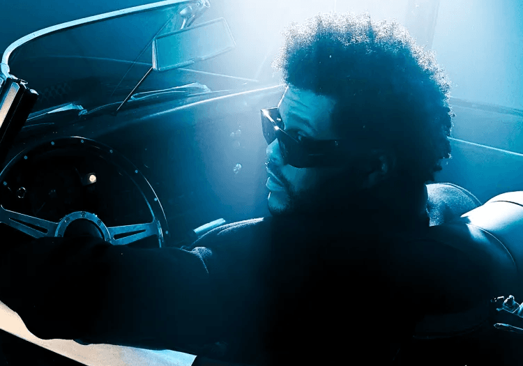 The Weeknd looking back in his car