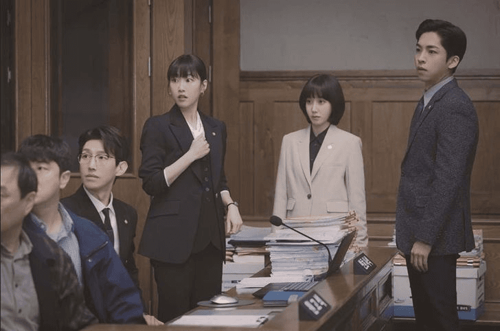 Woo and her colleagues in a board room