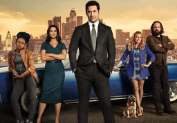 Lincoln Lawyer cast with blue Lincoln at sunset