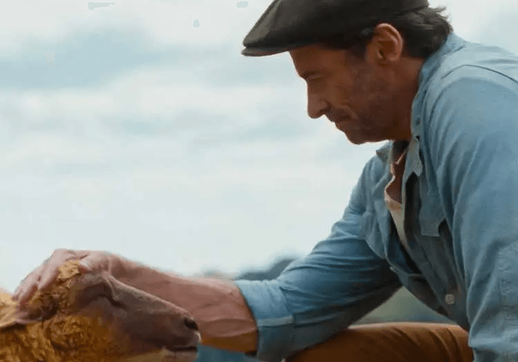 Hugh Jackman petting a sheep in The Sheep Detectives